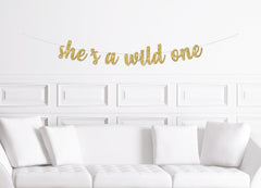 She&#39;s A Wild One Cursive Banner / Gold Script Glitter First Birthday Sign / Wilderness Forest Theme Decor / Girl&#39;s Party